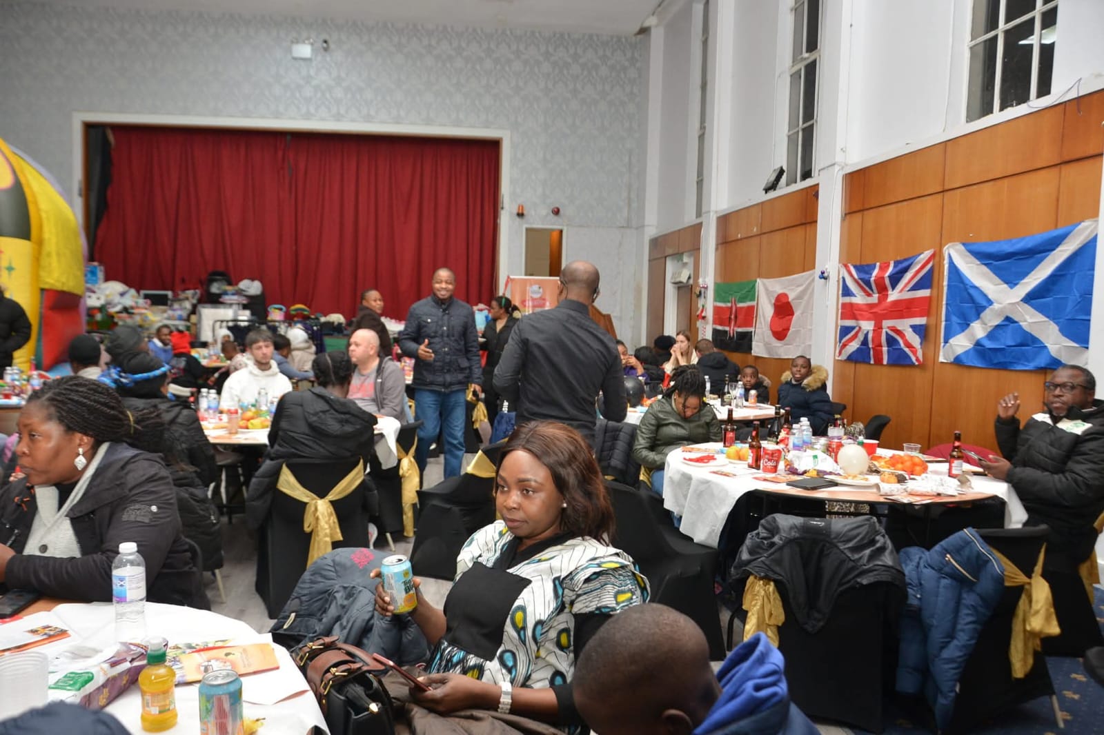 Large community gathering with international flags displayed