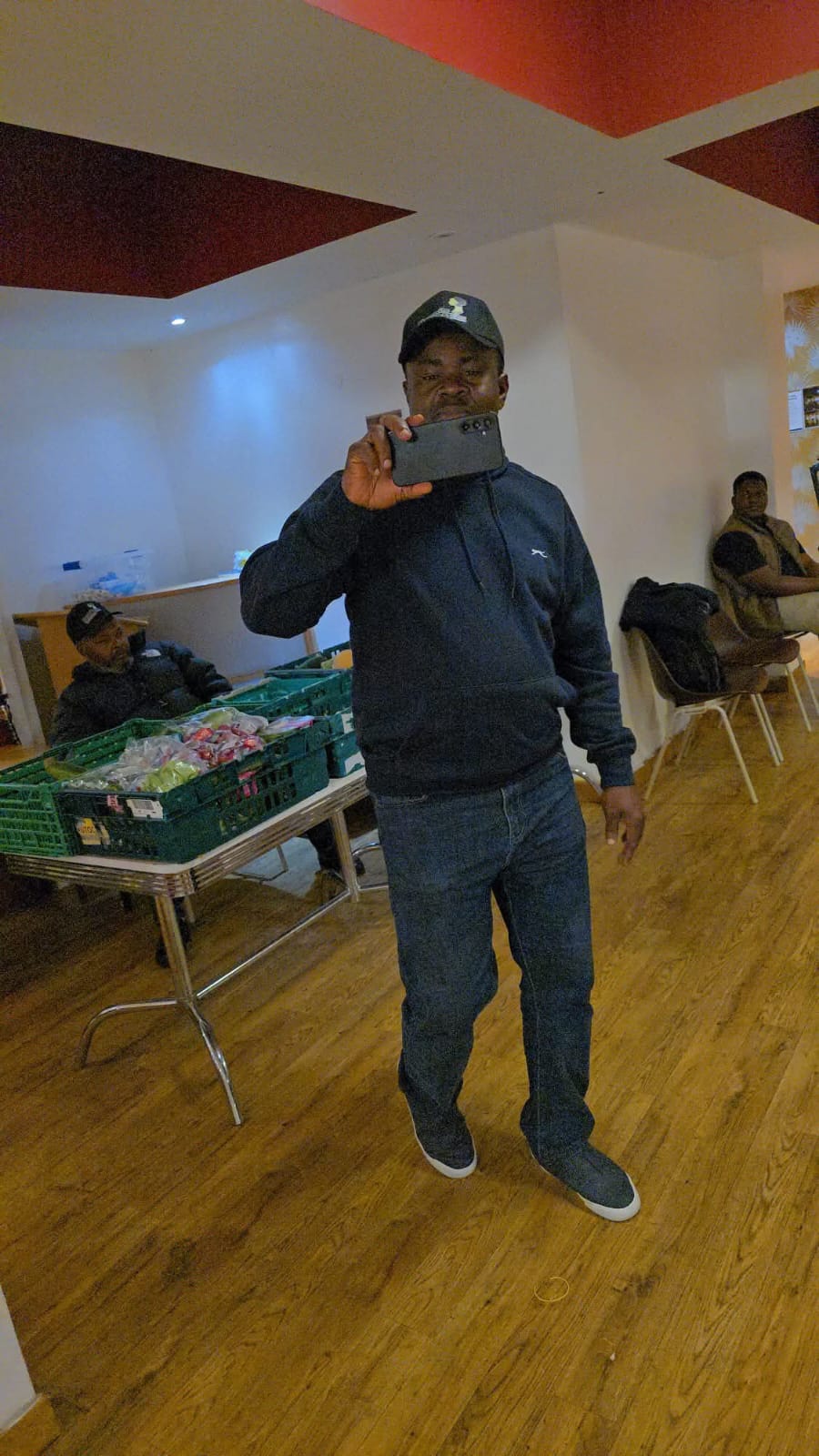 Man taking a selfie with tablet at community event