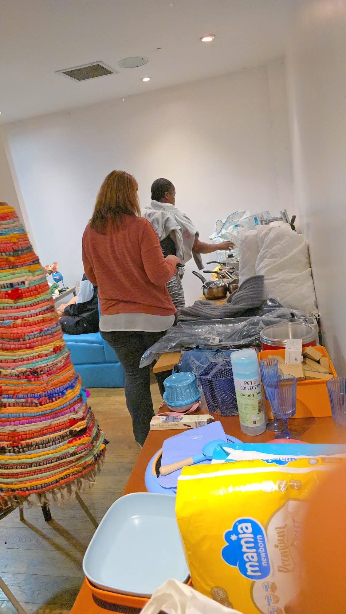 Colorful woven baskets with people in background
