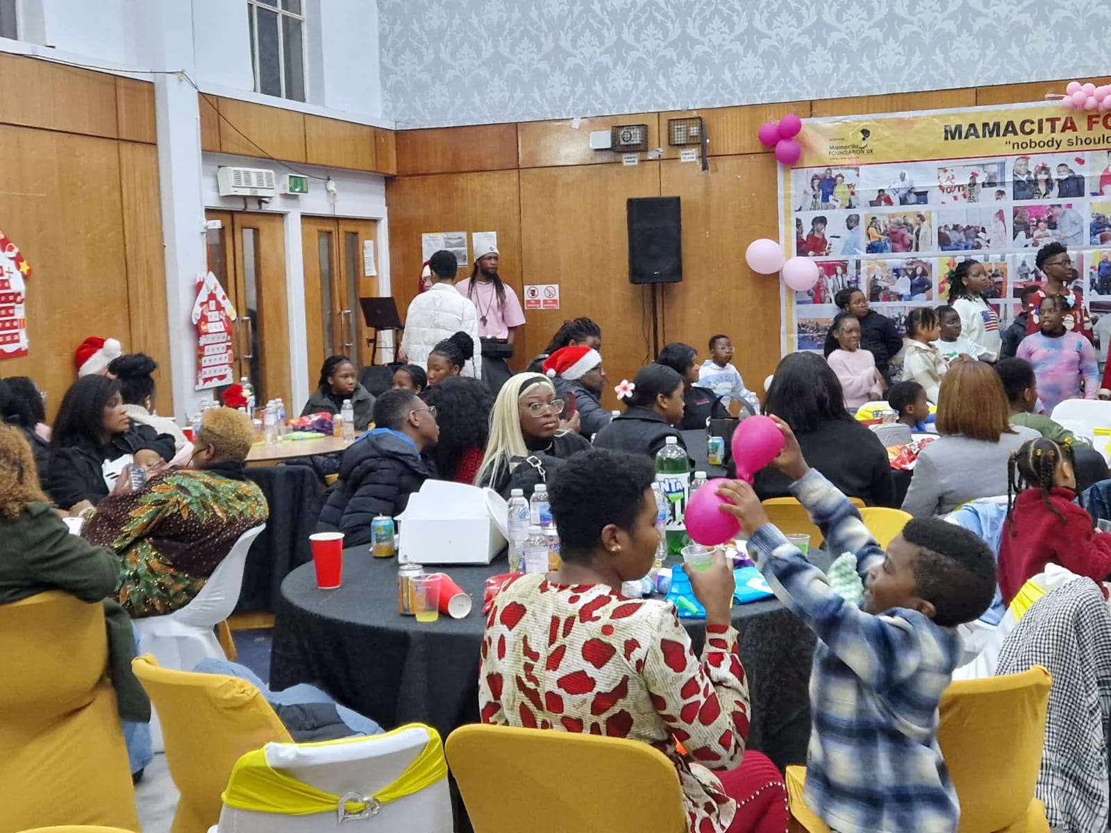 Community gathering with yellow chairs and decorations