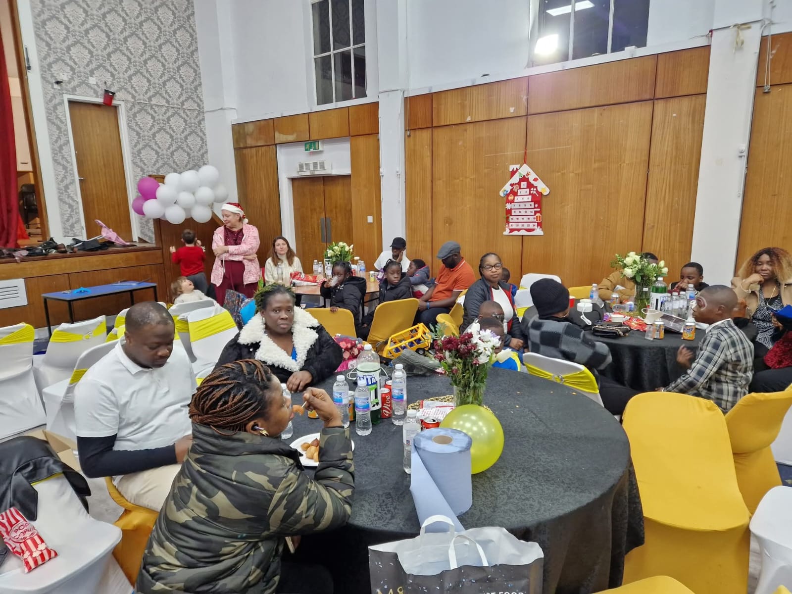 Seated attendees at formal community gathering